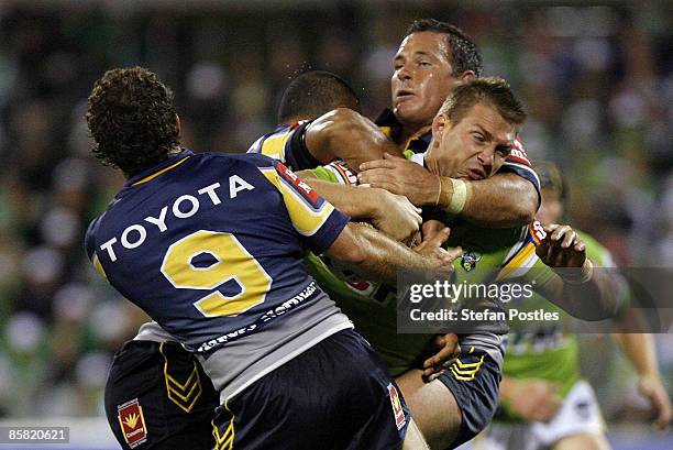 Scott Logan of the Raiders is tackled during the round four NRL match between the Canberra Raiders and the North Queensland Cowboys at Canberra...