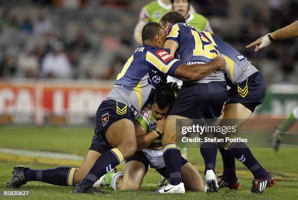 Justin Carney of the Raiders is tackled during the round four NRL match between the Canberra Raiders and the North Queensland Cowboys at Canberra...