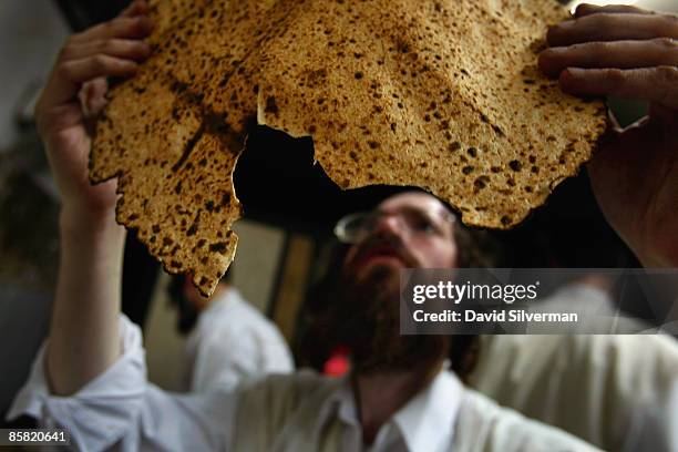 An ultra-Orthodox Jew inspects matza to ensure that the unleavened bread eaten in the upcoming Jewish holiday of Pesach is properly baked, on April...