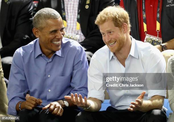 Former U.S. President Barack Obama and Prince Harry share a joke as they watch wheelchair baskeball on day 7 of the Invictus Games 2017 on September...