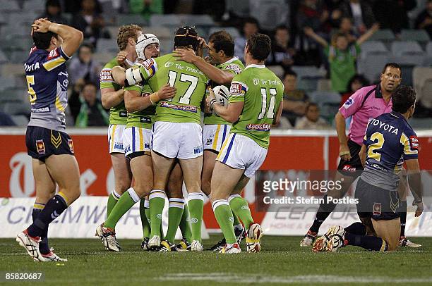 Raiders players celebrate after a try during the round four NRL match between the Canberra Raiders and the North Queensland Cowboys at Canberra...