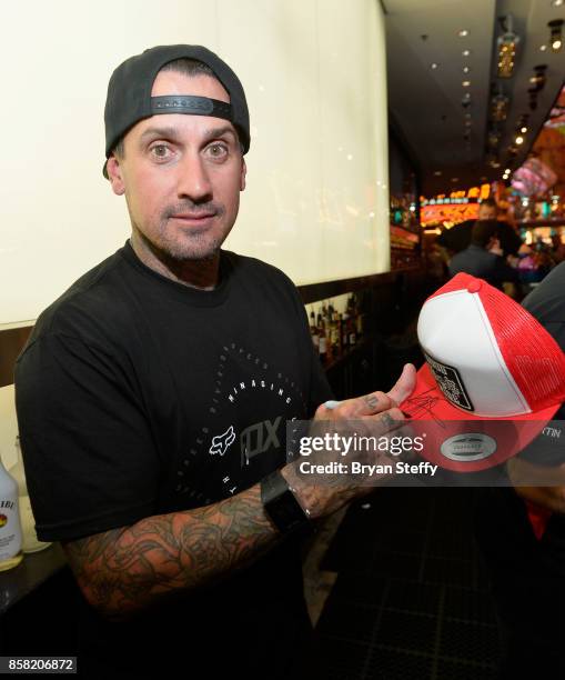 Freestyle motocross rider Carey Hart signs an autograph as he surprises guests as a bartender in support of Carey Hart's Good Ride Rally benefiting...