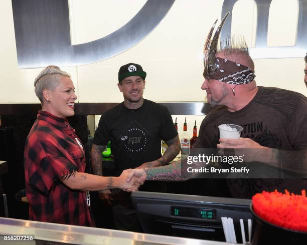 Recording artist Pink, freestyle motocross rider Carey Hart and television personality 'Horny' mike Henry attend a surprise event in support of Carey...