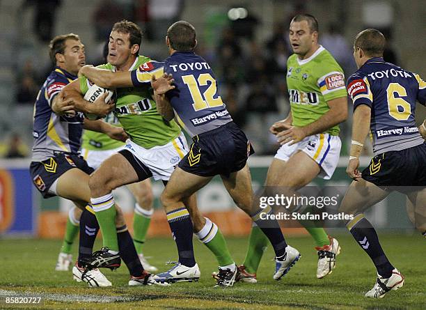 Terry Campese of the Raiders is tackled during the round four NRL match between the Canberra Raiders and the North Queensland Cowboys at Canberra...