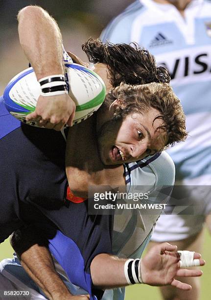 Marc Andreu of France is tackled by Argentina's Martin Bustos Moyano in their match at the International Rugby Sevens Adelaide tournament, in...