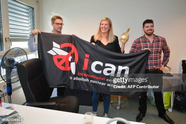 Nuclear disarmament group ICAN coordinator Daniel Hogsta, executive director Beatrice Fihn and her husband Will Fihn Ramsay pose with a banner...