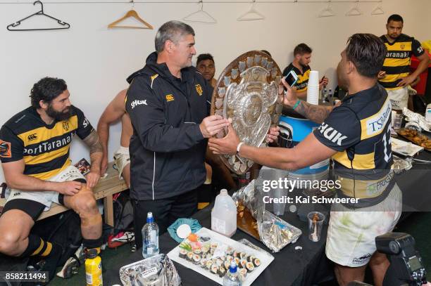 Seta Tamanivalu of Taranaki hands the Ranfurly Shield over to Head Coach Colin Cooper of Taranaki after the win in the round eight Mitre 10 Cup match...