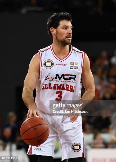 Kevin White of the Hawks dribbles the ball during the round one NBL match between the Cairns Taipans and the Illawarra Hawks at Cairns Convention...