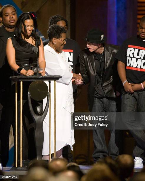 Connie Perry, mother of deceased Jason 'Jam Master Jay' Mizell shakes hands with Eminem during the 24th Annual Rock and Roll Hall of Fame Induction...