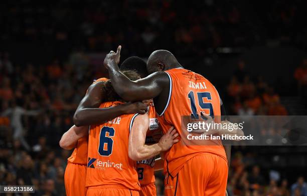 The Taipans team gather in a huddle during the round one NBL match between the Cairns Taipans and the Illawarra Hawks at Cairns Convention Centre on...