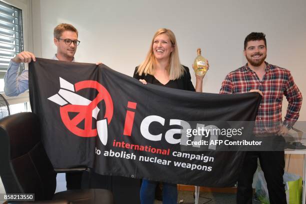 Nuclear disarmament group ICAN coordinator Daniel Hogsta, executive director Beatrice Fihn and her husband Will Fihn Ramsay pose with a banner...