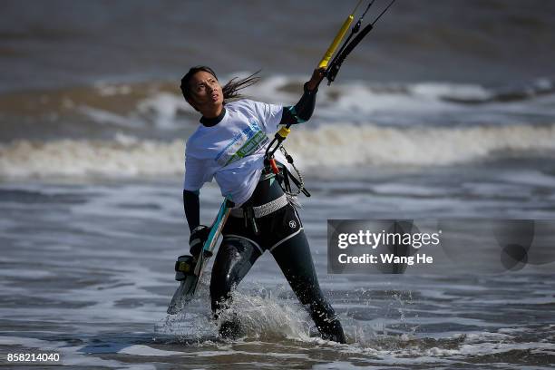 The Female Kite surfers prepares his kite at Qidong Golden Beach before the start of the 3rd Qidong YuanTuoJiao Kite Surfing Invitational Tournament...