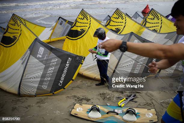 The Kite surfers prepares their kite at Qidong Golden Beach before the start of the 3rd Qidong YuanTuoJiao Kite Surfing Invitational Tournament on...