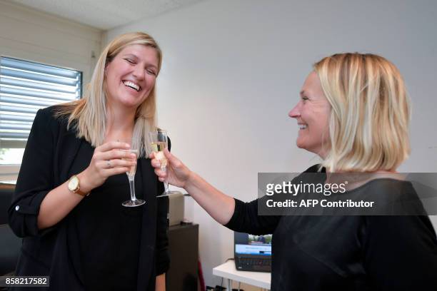 Nuclear disarmament group ICAN executive director Beatrice Fihn and member of the steering committee Grethe Ostern celebrate with champagne after...