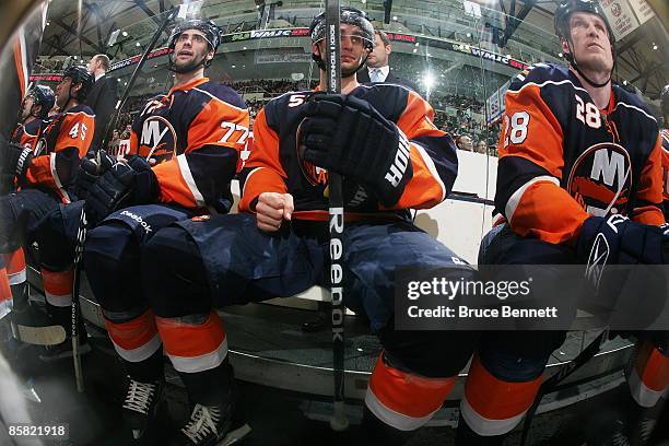 Trevor Smith, Frans Nielsen and Tim Jackman of the New York Islanders wait for their shifts during the game against the Montreal Canadiens on April...