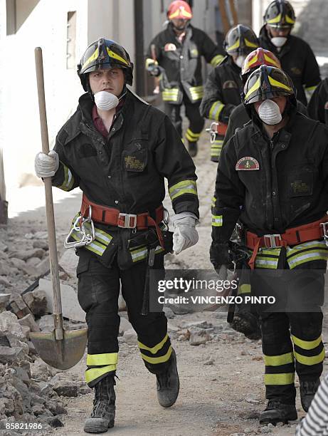 Firemen walk on April 6, 2009 in a damaged street of Onna, a small town some 10 kilometers from L'Aquila, epicentre of an earthquake which jolted...