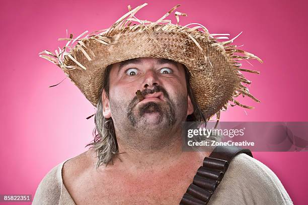 mexican outlaw man character portrait on pink - strohhut stock-fotos und bilder