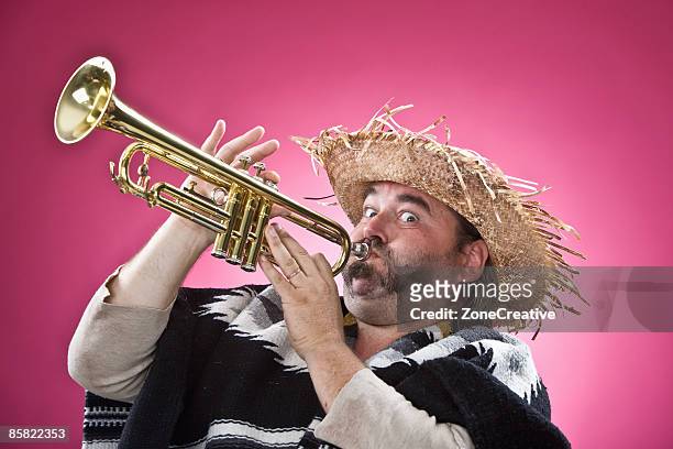mexican fat character man playing trumpet - indoor play zone stock pictures, royalty-free photos & images