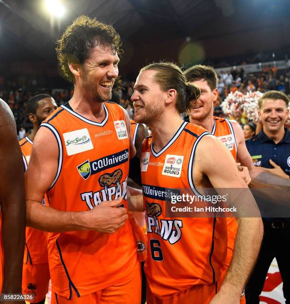 Alex Loughton of the Taipans and Damon Heir of the Taipans celebrate after winning the round one NBL match between the Cairns Taipans and the...