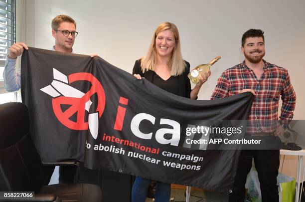 Nuclear disarmament group ICAN coordinator Daniel Hogsta, executive director Beatrice Fihn and her husband Will Fihn Ramsay pose with a banner...