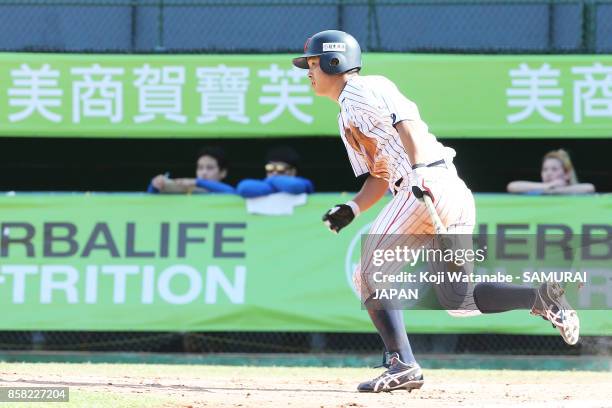 Shoji Kitamura of Japan hits a RBI single in the bottom half of the eight inning during the 28th Asian Baseball Championship Super Round match...