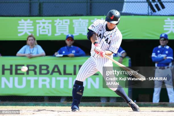 Kazuki Kamizato of Japan hits a RBI single in the bottom half of the eight inning during the 28th Asian Baseball Championship Super Round match...