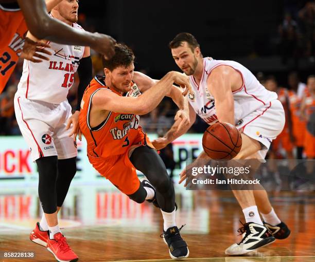 Cam Gliddon of the Taipans attempts to get a pass away during the round one NBL match between the Cairns Taipans and the Illawarra Hawks at Cairns...