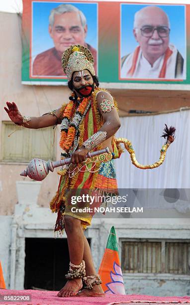 An Indian artist dressed like the Hindu God Lord Hanuman entertains the crowd during the Bharatiya Janatha Party election campaign public meeting in...