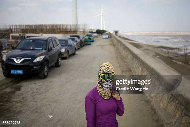 Woman wears a face-kini in Qidong Golden Beach during the 3rd Qidong YuanTuoJiao Kite Surfing Invitational Tournament on October 6, 2017 in Nantong,...