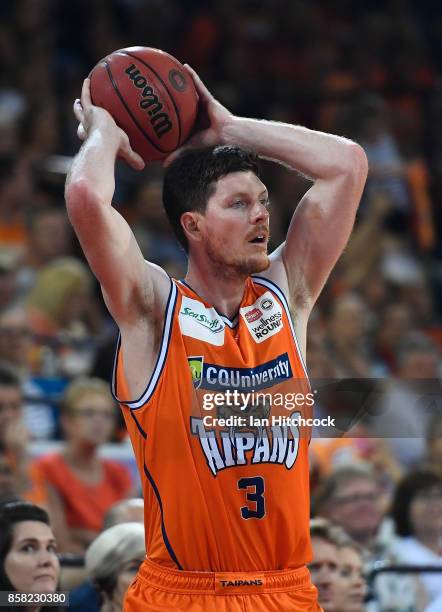 Cam Gliddon of the Taipans looks to pass the ball during the round one NBL match between the Cairns Taipans and the Illawarra Hawks at Cairns...