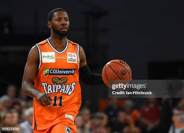 Scoochie Smith of the Taipans dribbles the ball during the round one NBL match between the Cairns Taipans and the Illawarra Hawks at Cairns...
