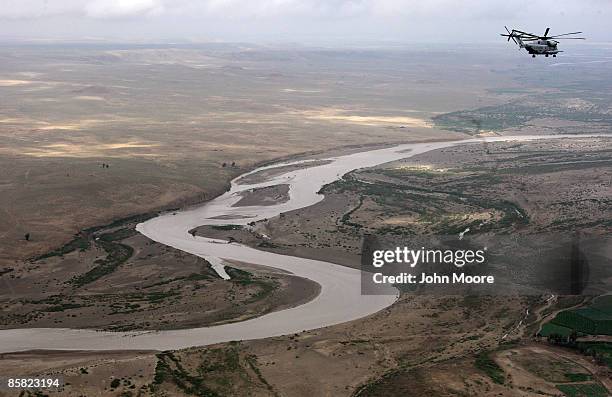 Marine CH-53 transport helicopter flies over a branch of the Helmand River and opium poppy fields April 6, 2009 in Helmand province, Afghanistan. The...