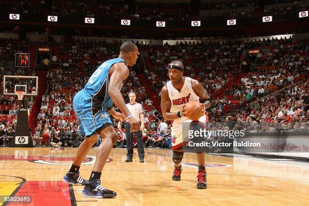 Jermaine O'Neal of the Miami Heat drives the ball against Dwight Howard of the Orlando Magic during the game on March 30, 2009 at American Airlines...