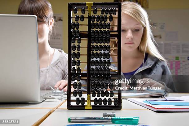 two students with abacus and computer - abacus computer fotografías e imágenes de stock