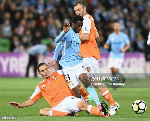 Bruce Kamau of the City is tackled by Jade North of the Roar during the round one A-League match between Melbourne City FC and the Brisbane Roar at...