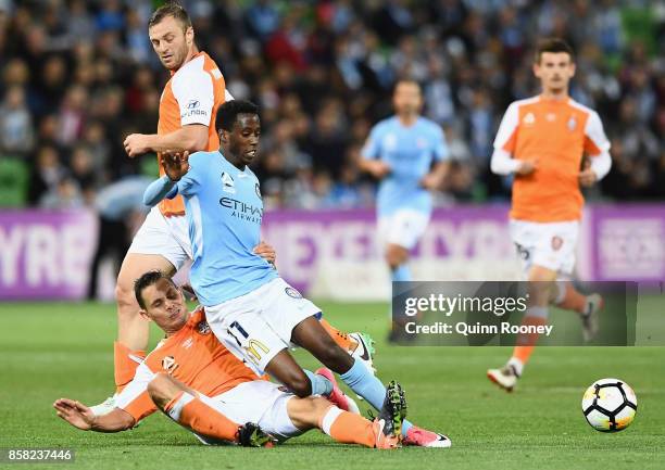 Bruce Kamau of the City is tackled by Jade North of the Roar during the round one A-League match between Melbourne City FC and the Brisbane Roar at...