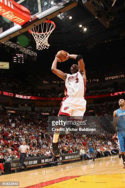 Dwyane Wade of the Miami Heat puts up a shot around Rashard Lewis of the Orlando Magic during the game on March 30, 2009 at American Airlines Arena...