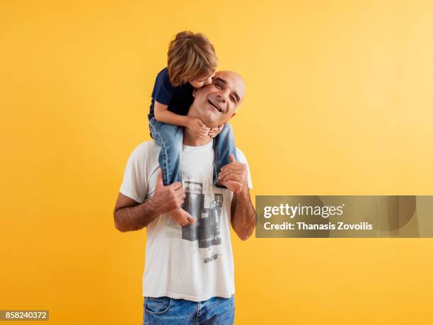 6 year old boy playing with his father - studio relations stock pictures, royalty-free photos & images