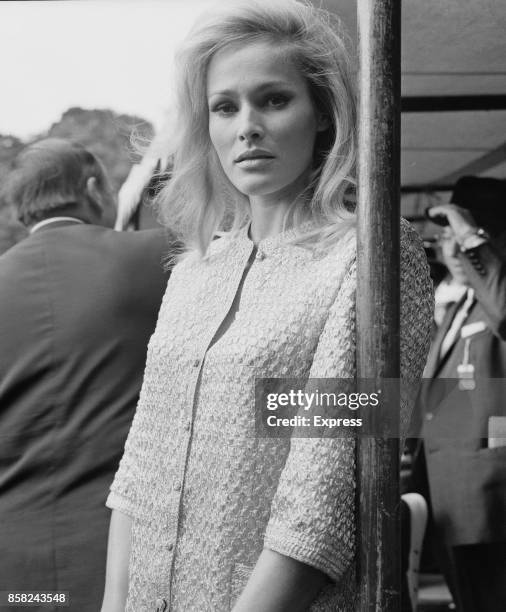 Swiss actress Ursula Andress attends a race meeting to raise money for charity at Sandown Park Racecourse, Escher, Surrey, UK, 31st August 1964.