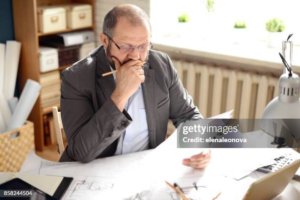 älterer erwachsener mann arbeitet im büro - steuerberater stock-fotos und bilder
