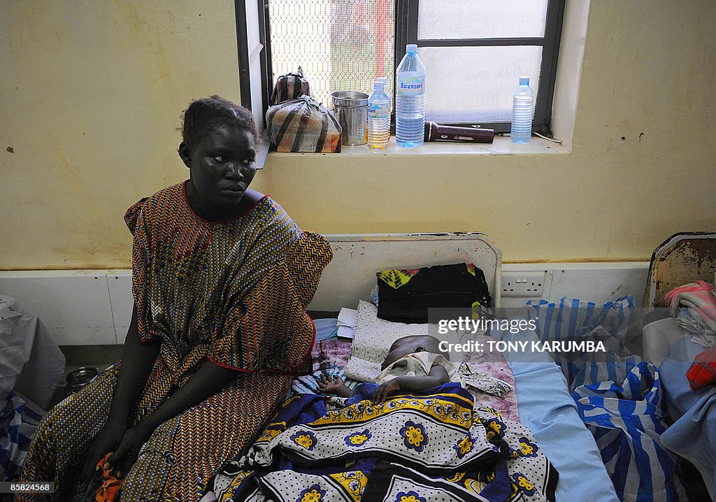 A south Sudanese mother looks over her m