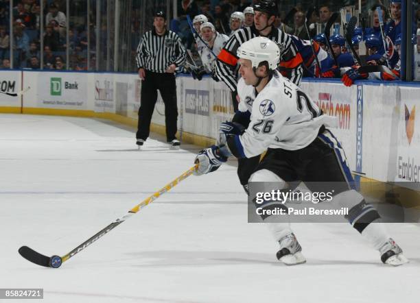 Martin St. Louis of the Tampa Bay Lightning moves the puck against the New York Islanders in a National Hockey League game at Nassau Coliseum on...