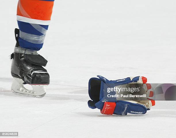 Hockey glove is kicked along the ice after a fight as the Tampa Bay Lightning and the New York Islanders played in a National Hockey League game at...
