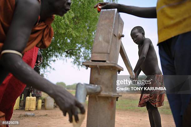 South Sudanese girl pumps water from a bore-hole on April 2 in Terekeka, 82 km north of Juba, an area where the population is exposed to malaria, a...
