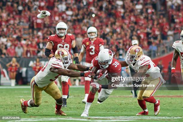 Arizona Cardinals running back Andre Ellington runs with the football battling with San Francisco 49ers cornerback Jimmie Ward and San Francisco...