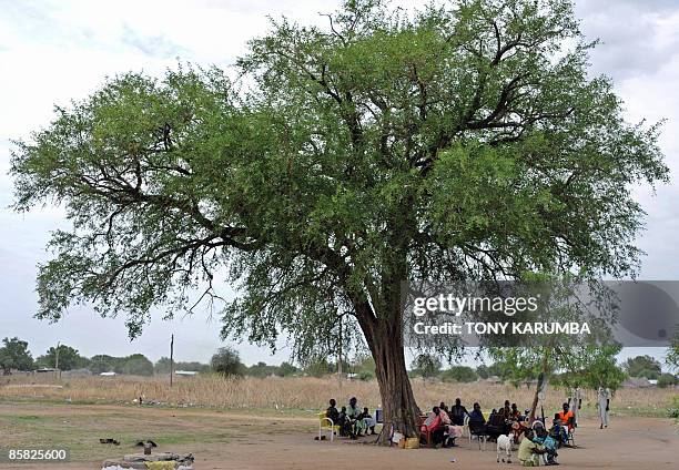 South Sudanese parents and their children attend an open-air clinic on April 2 at Terekeka, 82 km north of Juba, an area where the population is...