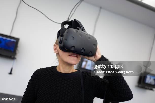 Visitor using VR-Glases in the exhibition room of Bayerisches Landeskriminalamt seen during the 'Perception is Reality: Ueber die Konstruktion von...