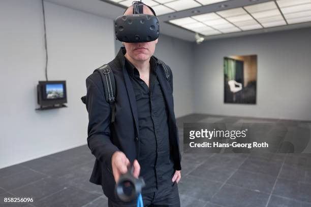 Visitor using VR-Glases in the exhibition room of Bayerisches Landeskriminalamt seen during the 'Perception is Reality: Ueber die Konstruktion von...