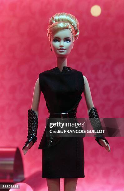 Barbie doll dressed up in a creation of French designer Karl Lagerferld is displayed on April 6, 2009 in Paris during the "Barbie Fashion show 2009",...