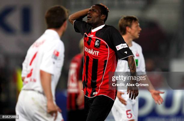 Mohamadou Idrissou of Freiburg despairs after missing a chance at goal as Marcel Busch and Ole Kittner of Ahlen react during the Second Bundesliga...